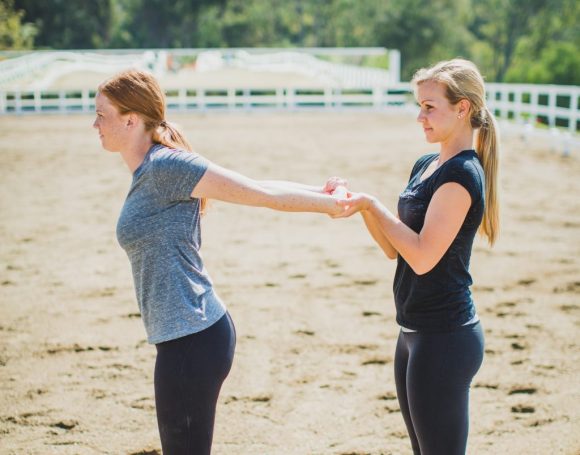 Find a partner and have some extra help stretching the front of your shoulders.